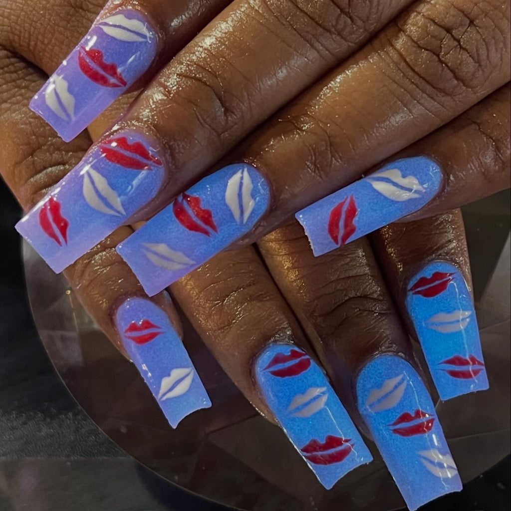  Glow in the dark Nails with blue and red designs kisses on a hand